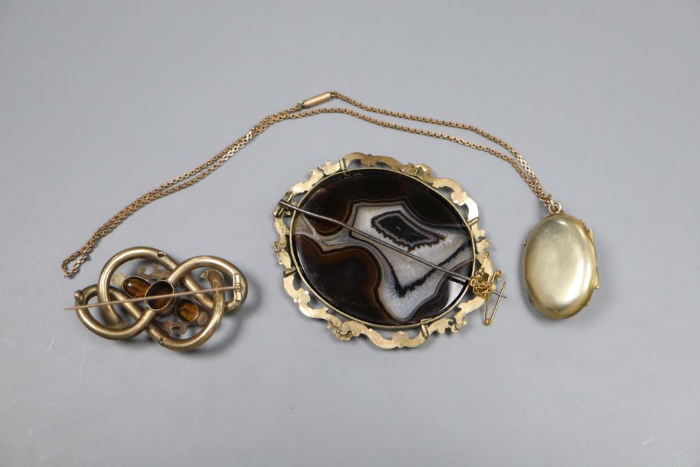 Two Victorian gilt metal brooches, a similar locket pendant on chain and a ladys silver cased wrist watch.